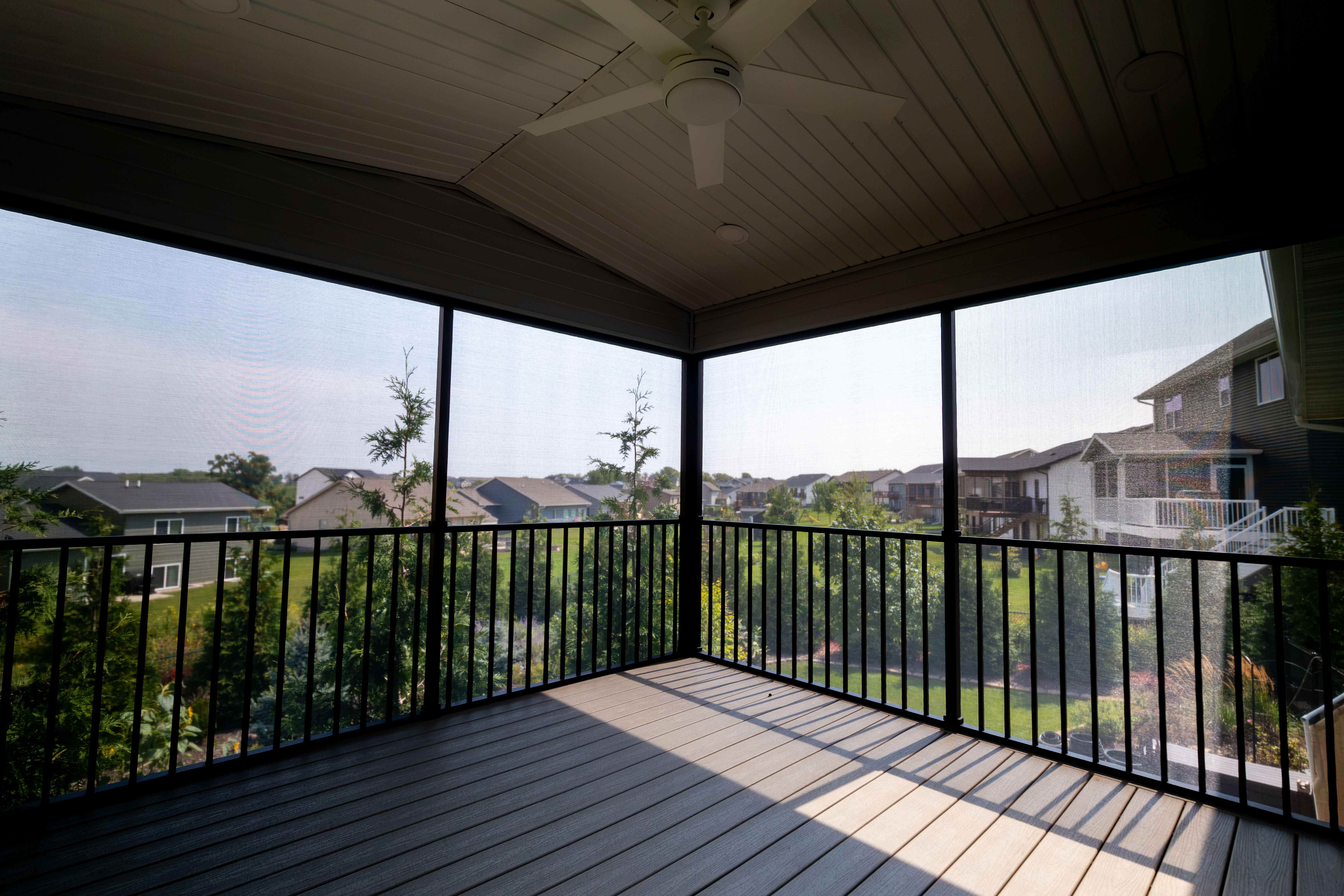 Custom-framed screen room with ceiling fan and composite decking